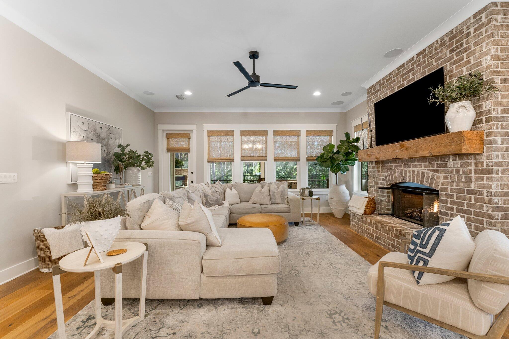 207 Pheasant Way Road Santa Rosa Beach, FL 32459 - Photo 25 of 70 a living room with furniture a fireplace and a flat screen tv