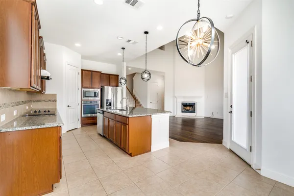 a very nice looking open kitchen with a stove