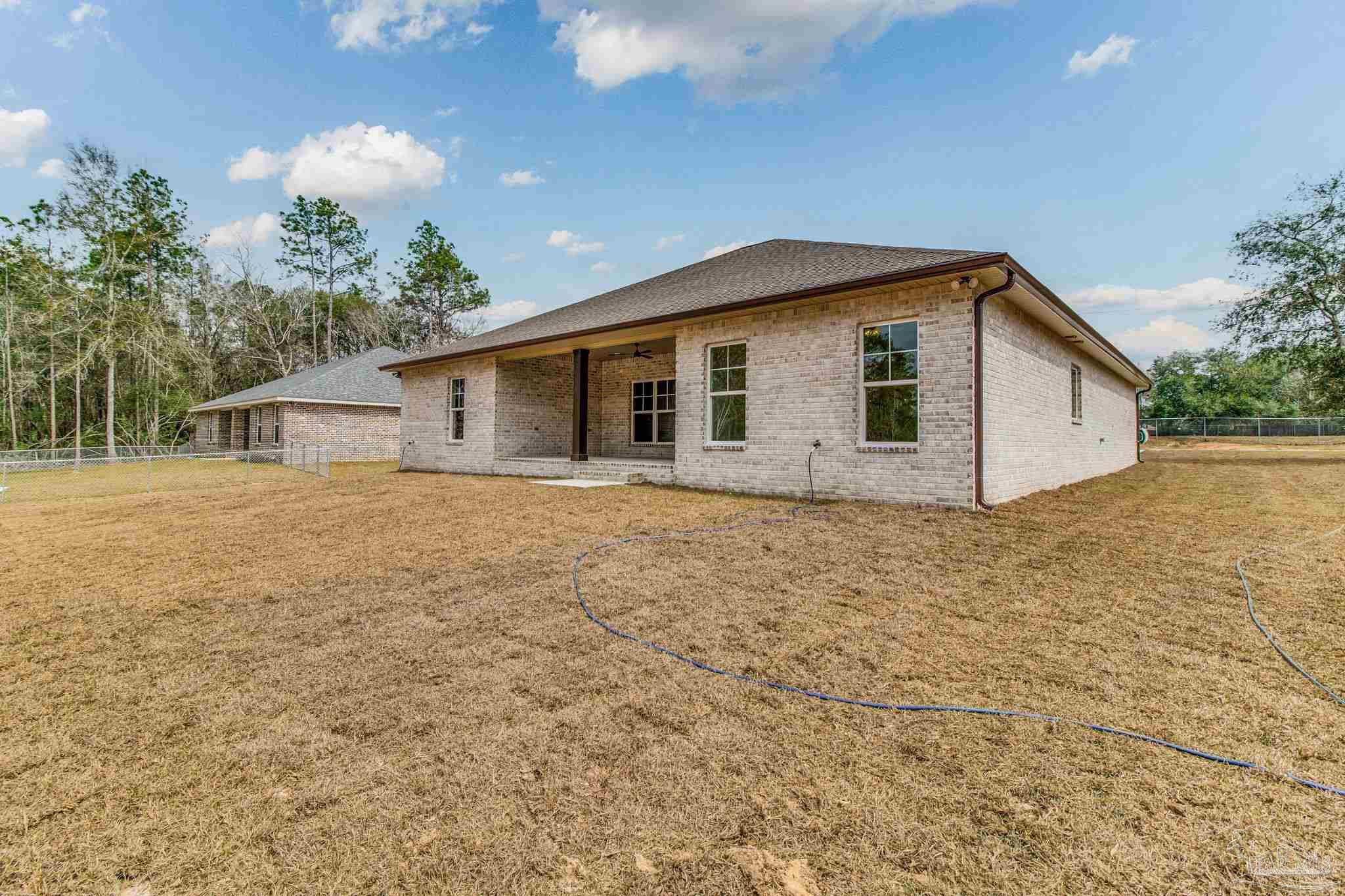 4310 Watkins Street Pace, FL 32571 - Photo 15 of 58 a view of a house with a yard