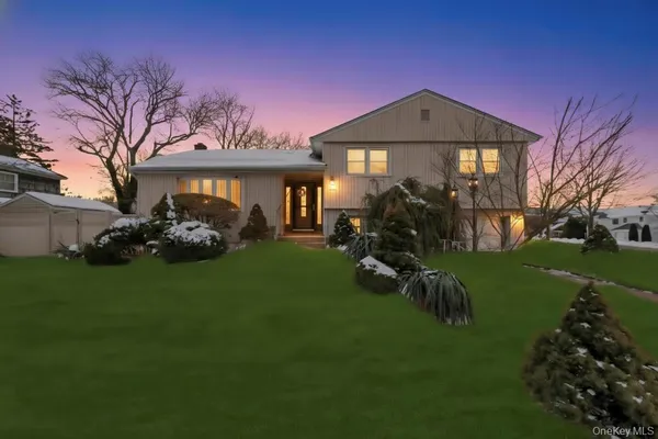 a front view of a house with a garden and pathway