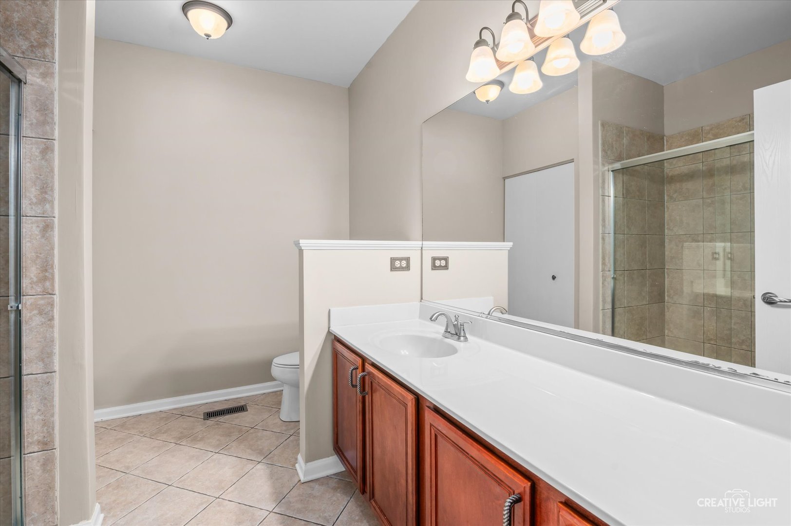 8814 Concord Lane, Unit H Justice, IL 60458 - Photo 11 of 17 a bathroom with a sink vanity and a mirror