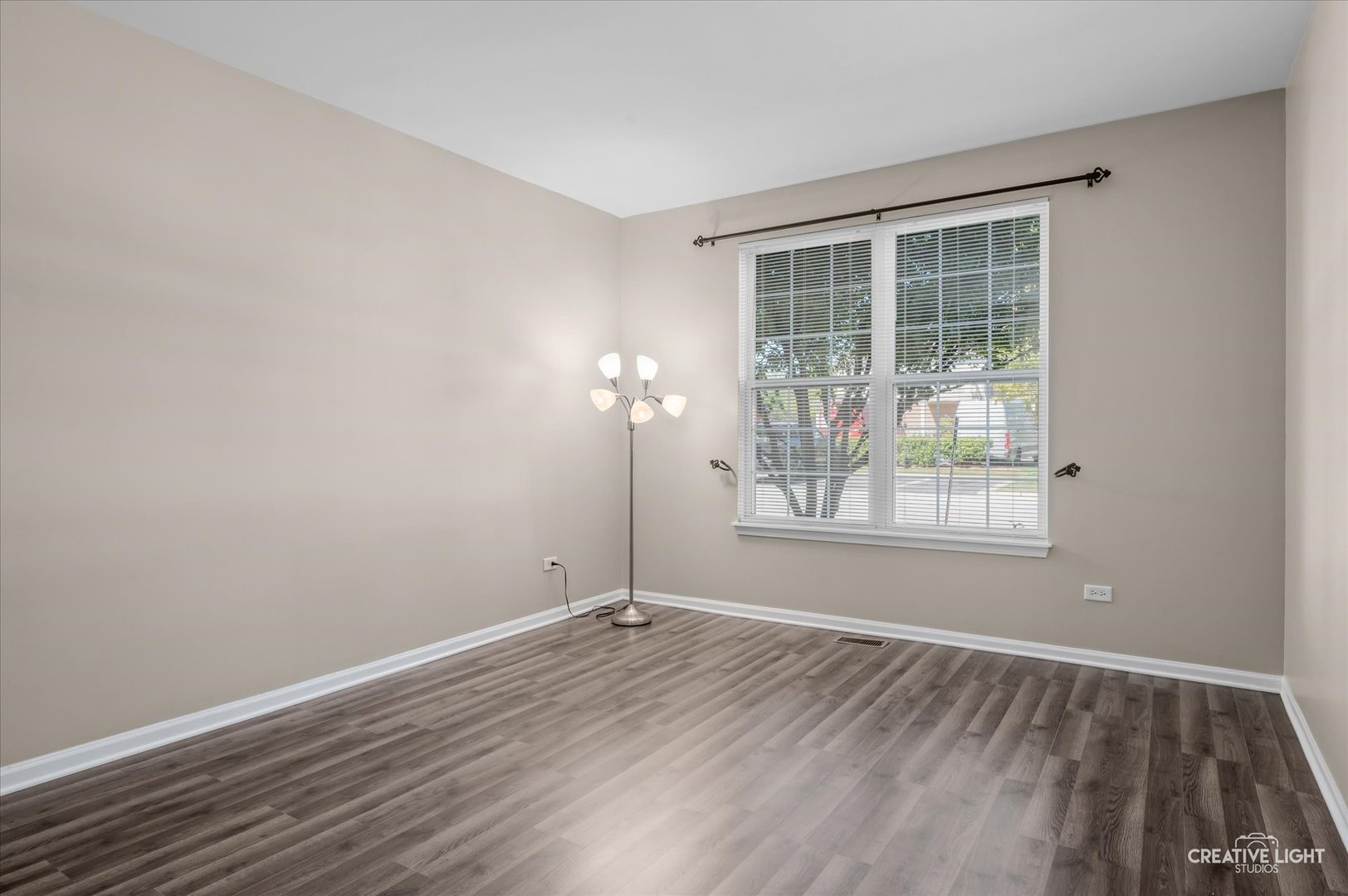 8814 Concord Lane, Unit H Justice, IL 60458 - Photo 10 of 17 an empty room with wooden floor and windows