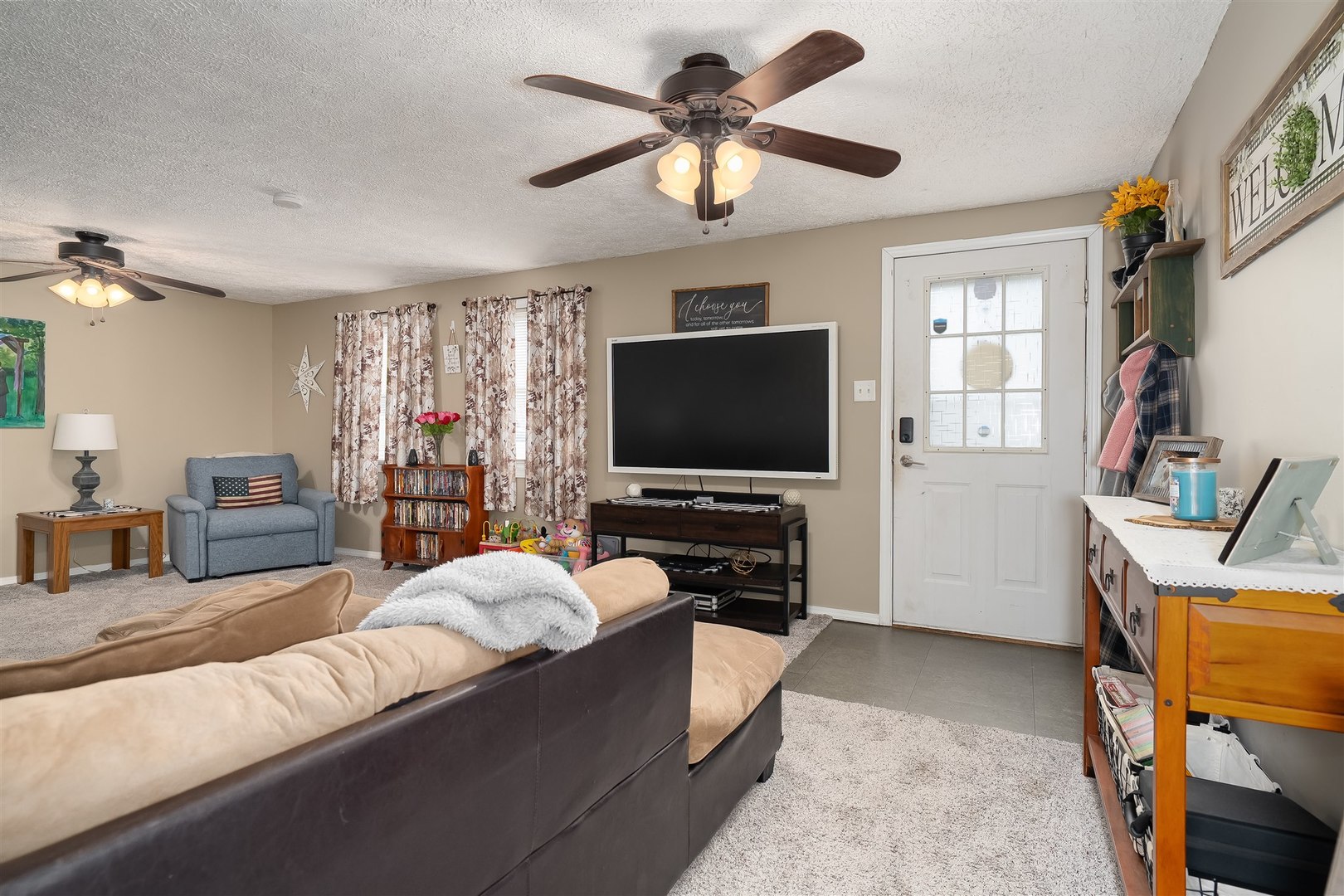 803 Sheridan Street Chenoa, IL 61726 - Photo 6 of 33 a living room with furniture and a flat screen tv