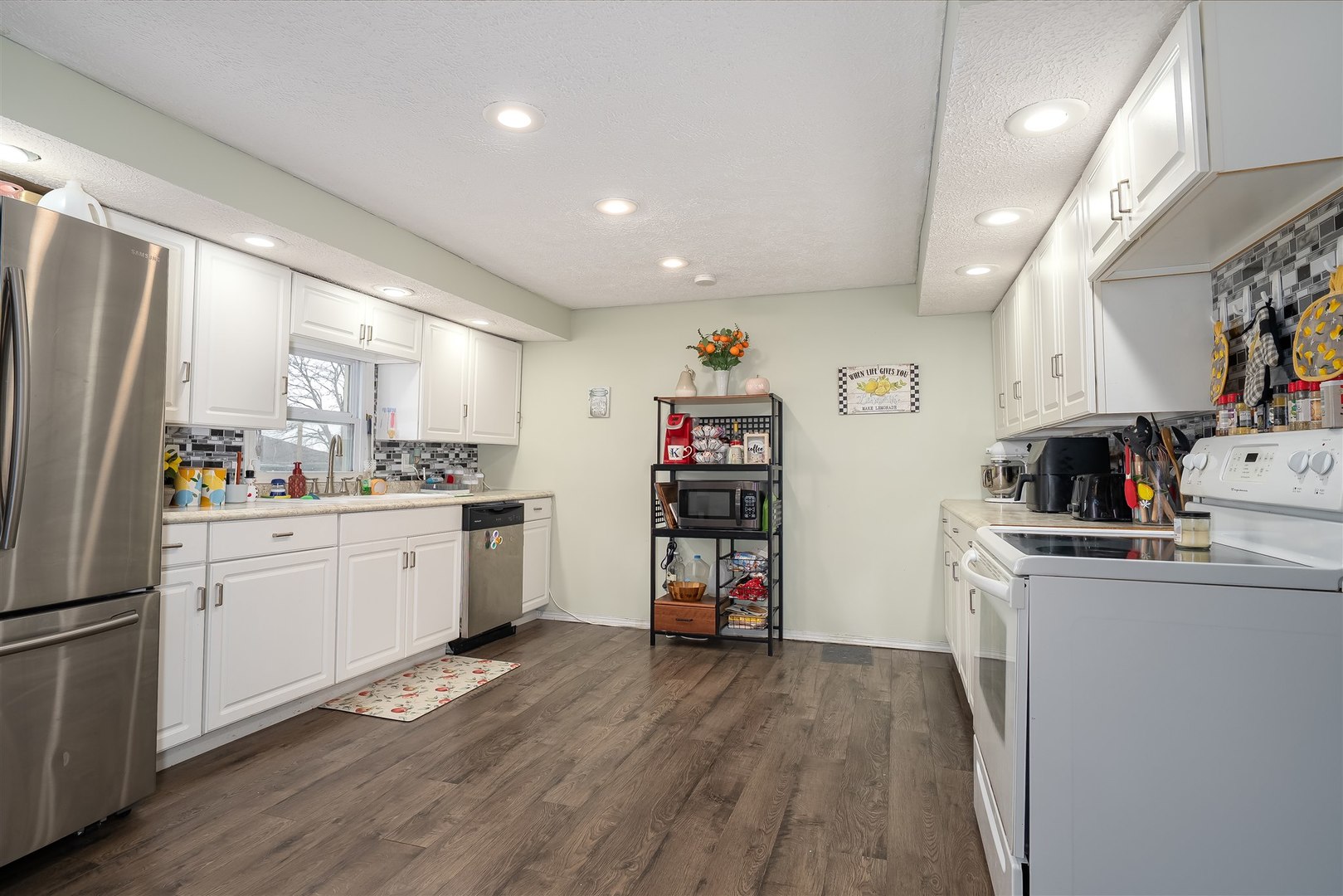 803 Sheridan Street Chenoa, IL 61726 - Photo 8 of 33 a kitchen with refrigerator a sink and wooden floor