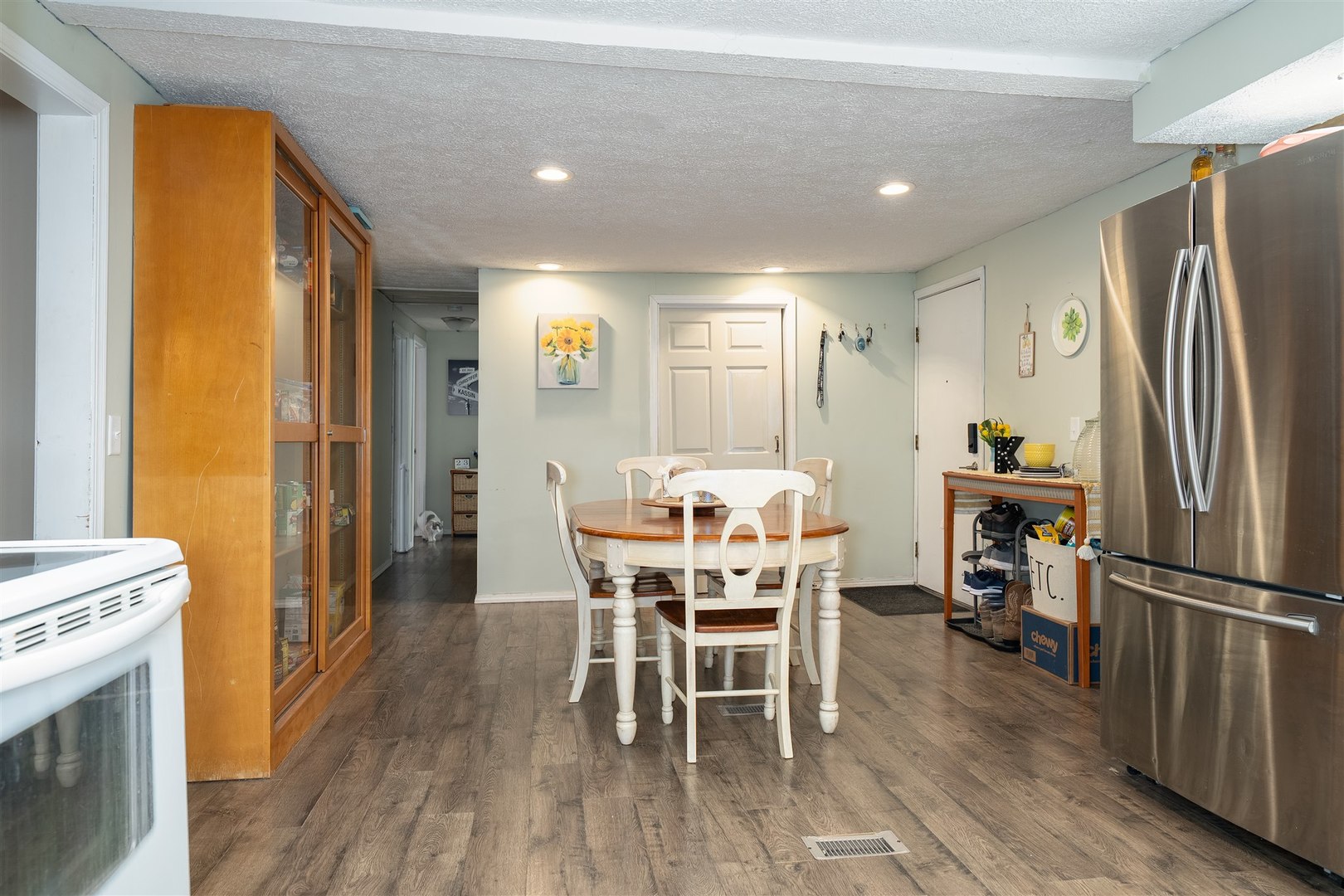 803 Sheridan Street Chenoa, IL 61726 - Photo 9 of 33 a dining room with a table chairs and a refrigerator