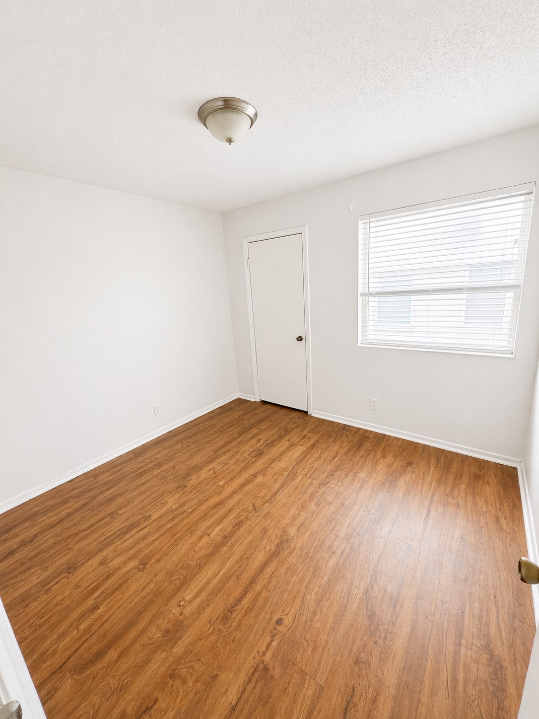 2307 Rachael Court, Unit D Austin, TX 78748 - Photo 5 of 7 an empty room with wooden floor and windows