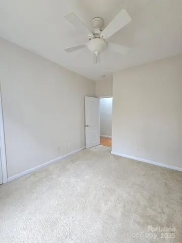 a view of an empty room with a ceiling fan