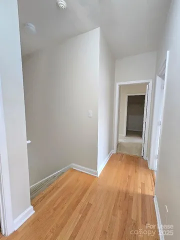 a view of a room with wooden floor and a sink