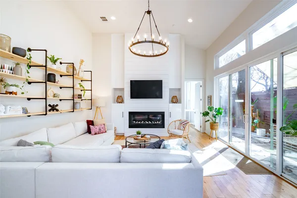 a living room with furniture a fireplace and a flat screen tv