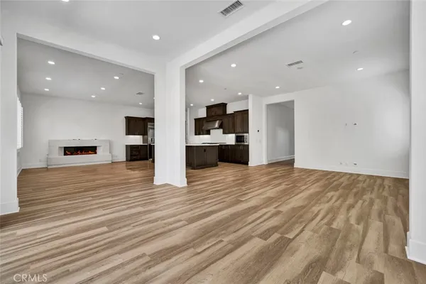 a view of kitchen with kitchen island granite countertop a large counter top stainless steel appliances and cabinets