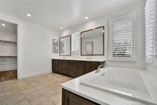 a bathroom with a bathtub sink and mirror