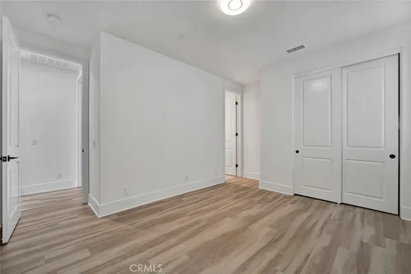 a view of room with wooden floor