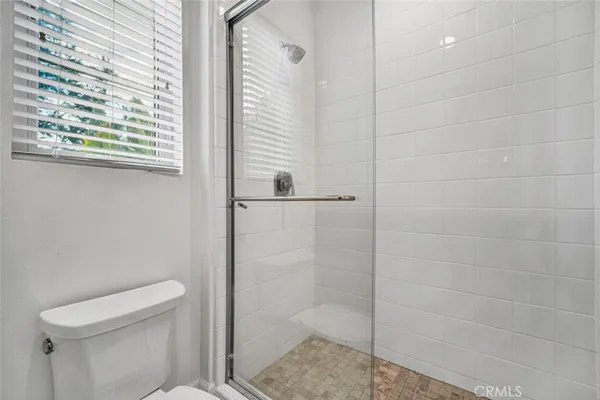 a bathroom with a shower and toilet