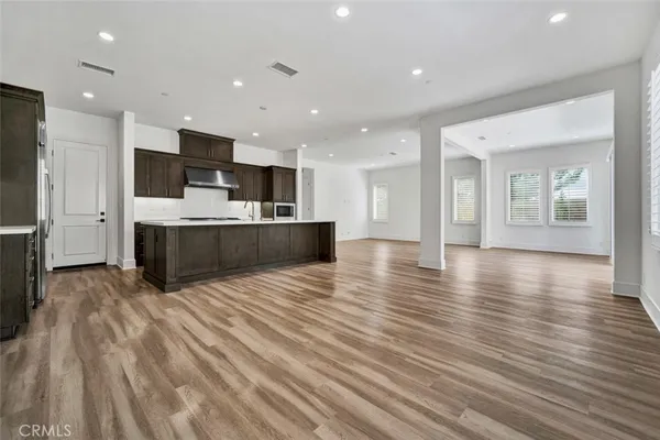 a view of kitchen and kitchen with sink large window