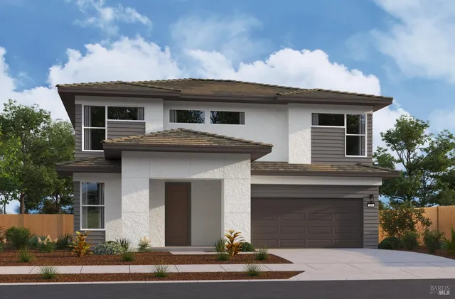 a front view of a house with a garden and garage