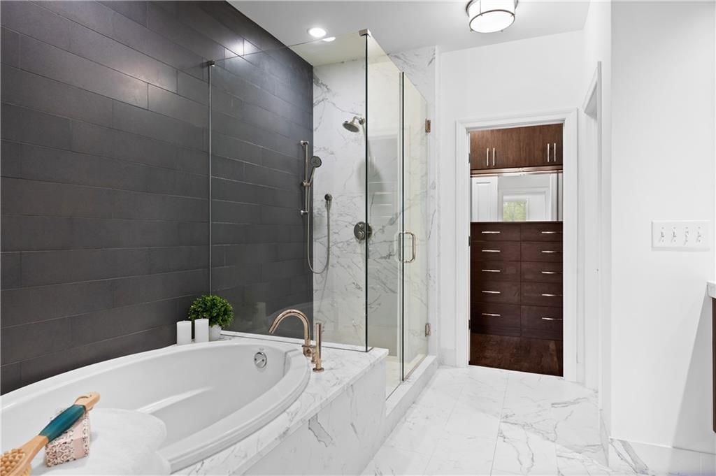 3681 Manor Brook Terrace Atlanta, GA 30319 - Photo 14 of 22 a bathroom with a bathtub and a shower