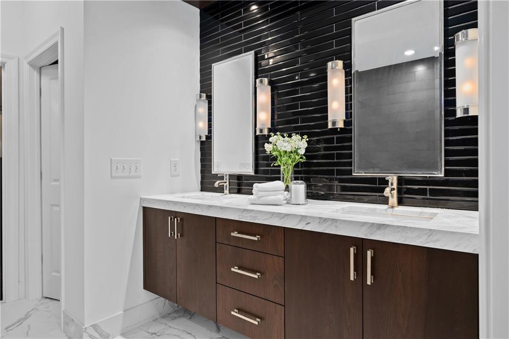 3681 Manor Brook Terrace Atlanta, GA 30319 - Photo 16 of 22 a bathroom with a granite countertop sink and a mirror