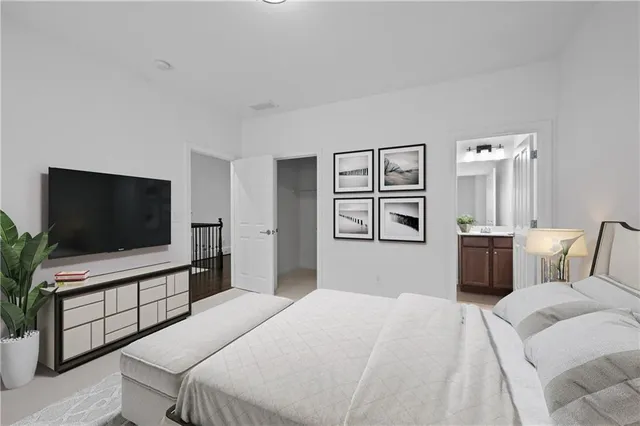 a bedroom with a bed and a flat screen tv