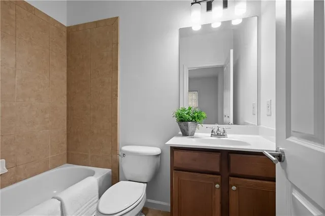 a bathroom with a sink vanity mirror and toilet