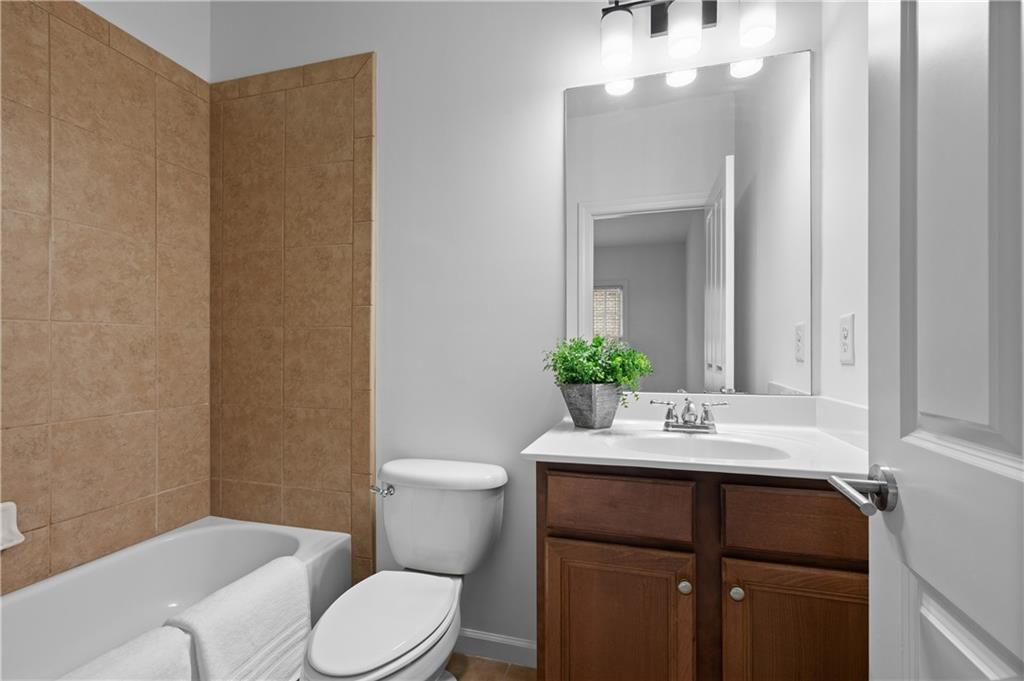 3681 Manor Brook Terrace Atlanta, GA 30319 - Photo 19 of 22 a bathroom with a sink vanity mirror and toilet