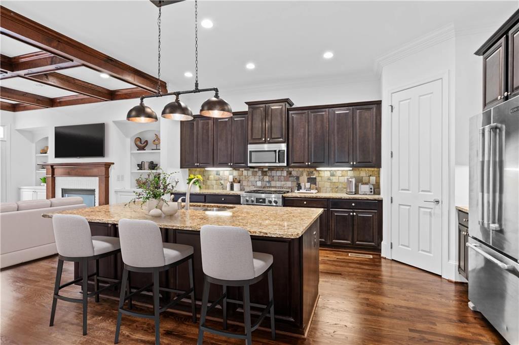 3681 Manor Brook Terrace Atlanta, GA 30319 - Photo 6 of 22 a kitchen with granite countertop kitchen island stainless steel appliances a dining table and chairs