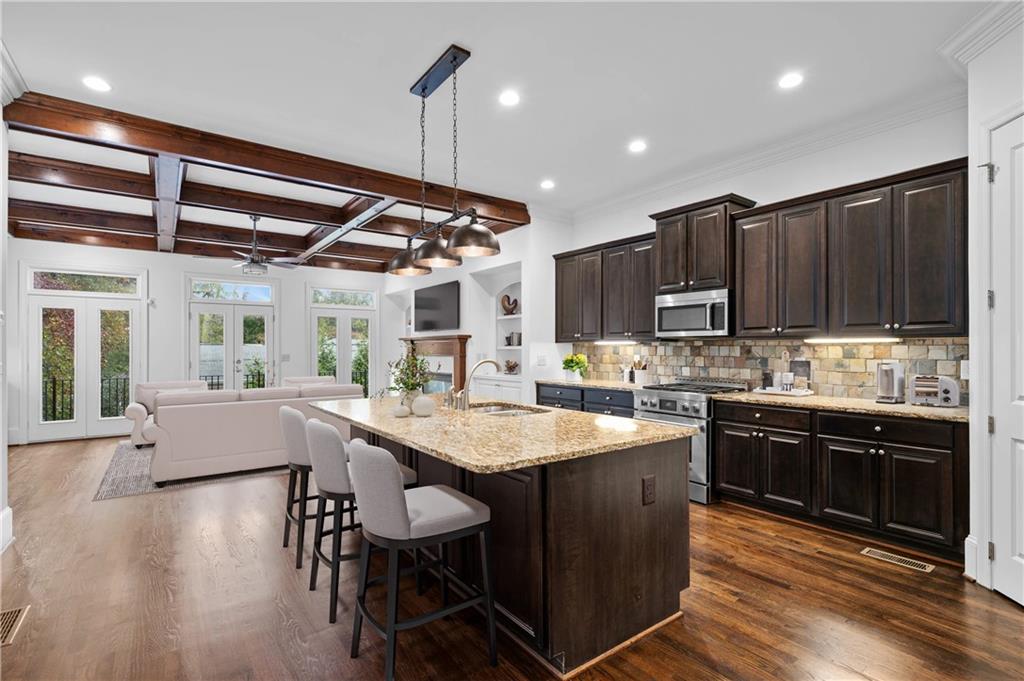 3681 Manor Brook Terrace Atlanta, GA 30319 - Photo 8 of 22 a kitchen with granite countertop a sink stainless steel appliances and cabinets