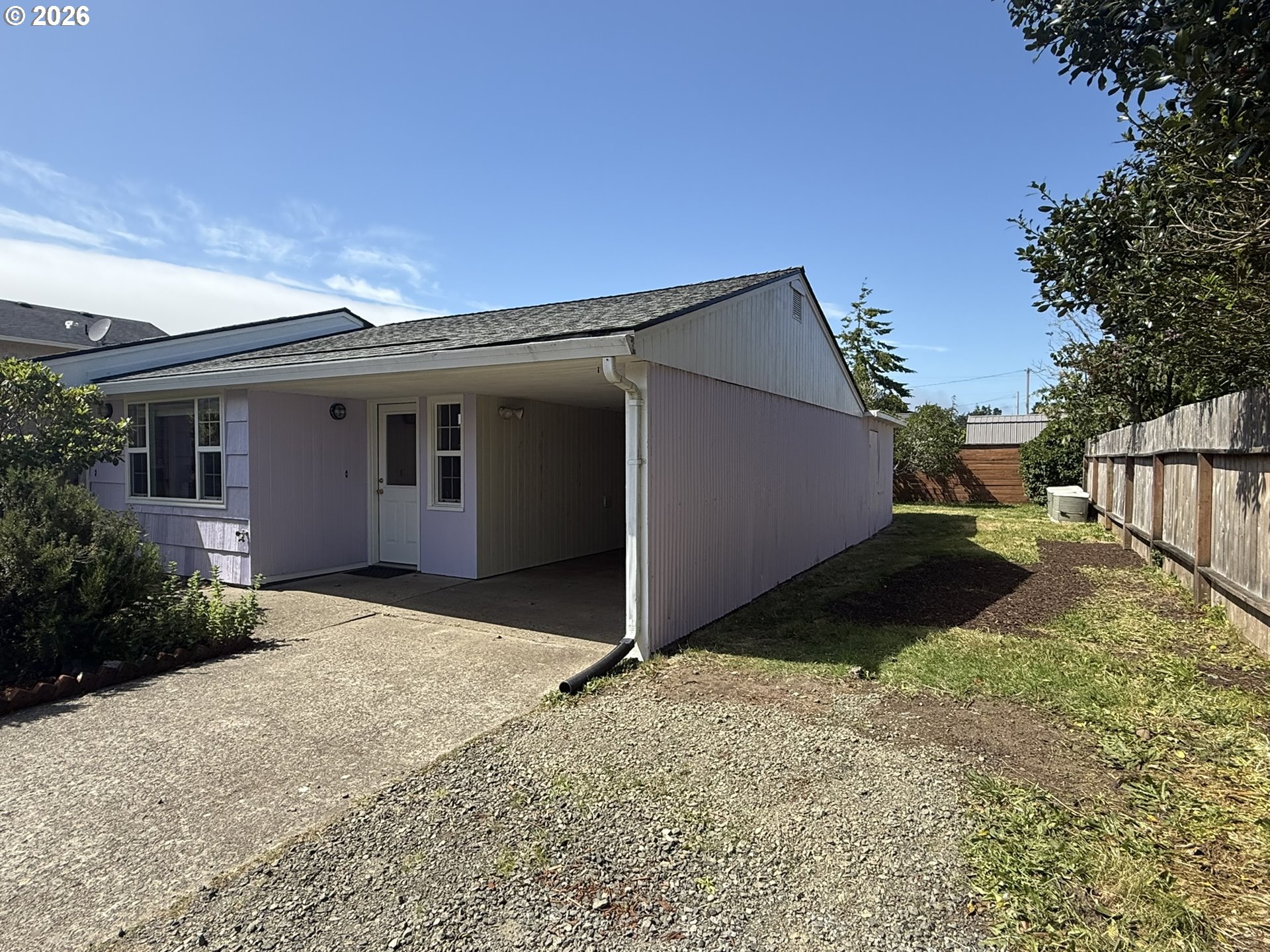 1179 6th Street Florence, OR 97439 - Photo 3 of 26 a backyard of a house with wooden fence
