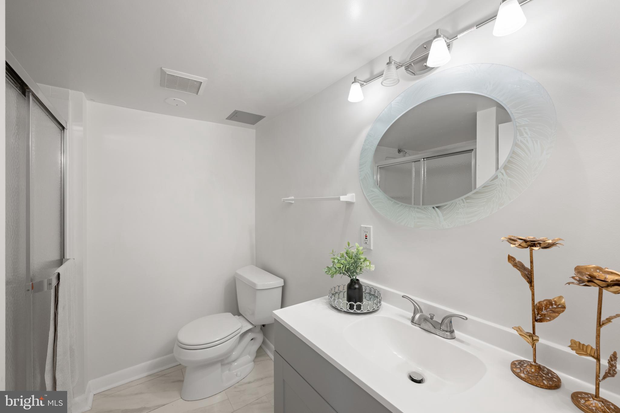 403 East Melbourne Avenue Silver Spring, MD 20901 - Photo 24 of 33 a bathroom with a toilet sink and mirror