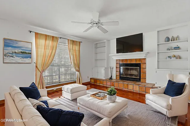 a view of a dining room with furniture a chandelier and wooden floor