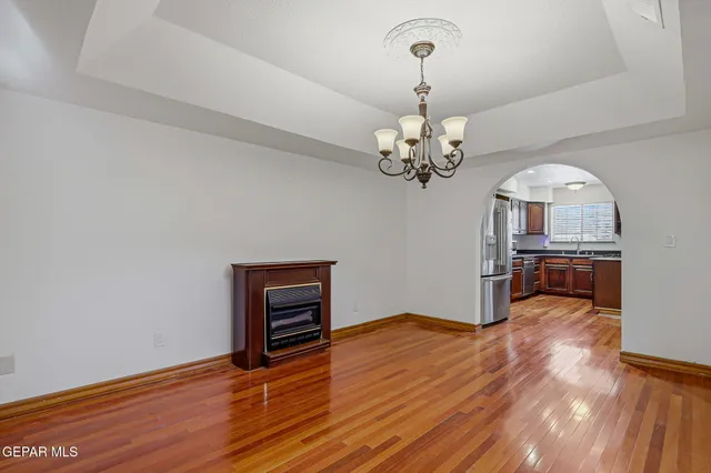 a view of a room with wooden floor chandelier and entryway