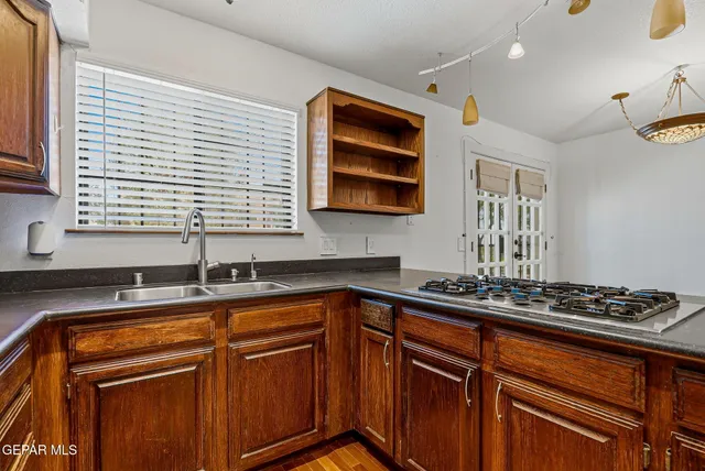 an empty room with wooden floor and window