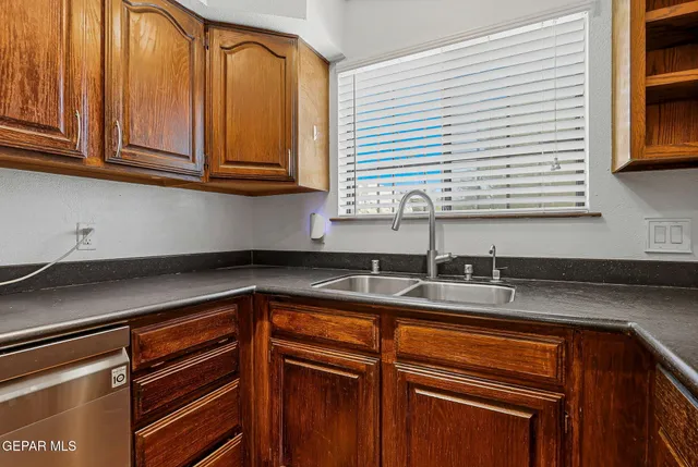 a living room with stainless steel appliances a dining table and a table