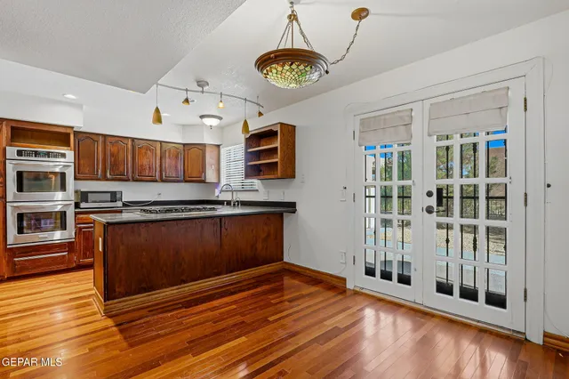 a living room with furniture a fireplace and a chandelier