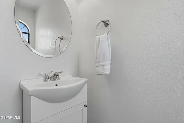 a view of a hallway with a door and stairs