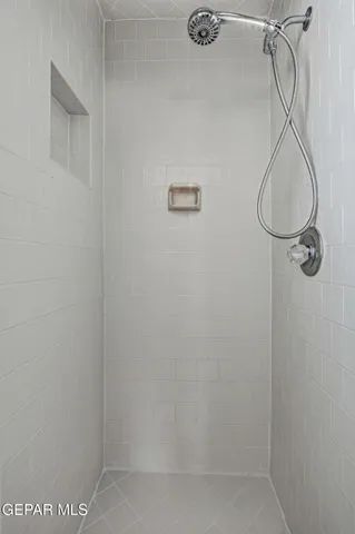 an empty room with chandelier fan