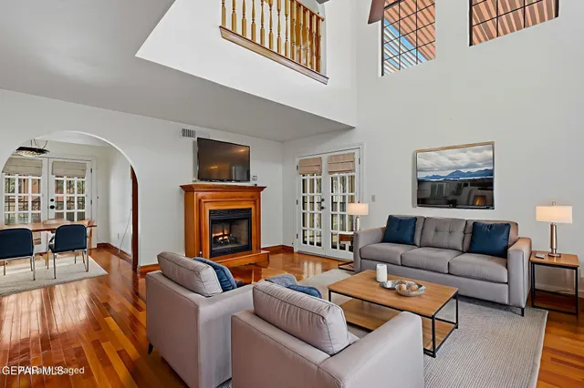 an empty room with wooden floor and fireplace