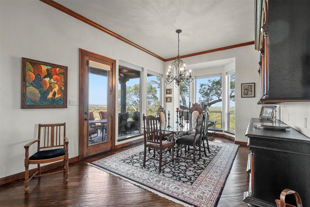 701 Cactus Rio Weatherford, TX 76087 - Photo 13 of 40 a view of a dining room with furniture a chandelier and wooden floor