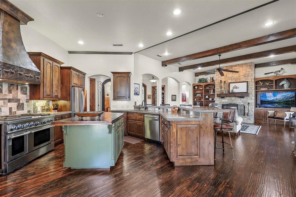 701 Cactus Rio Weatherford, TX 76087 - Photo 16 of 40 a kitchen with lots of counter top space and a wooden floor