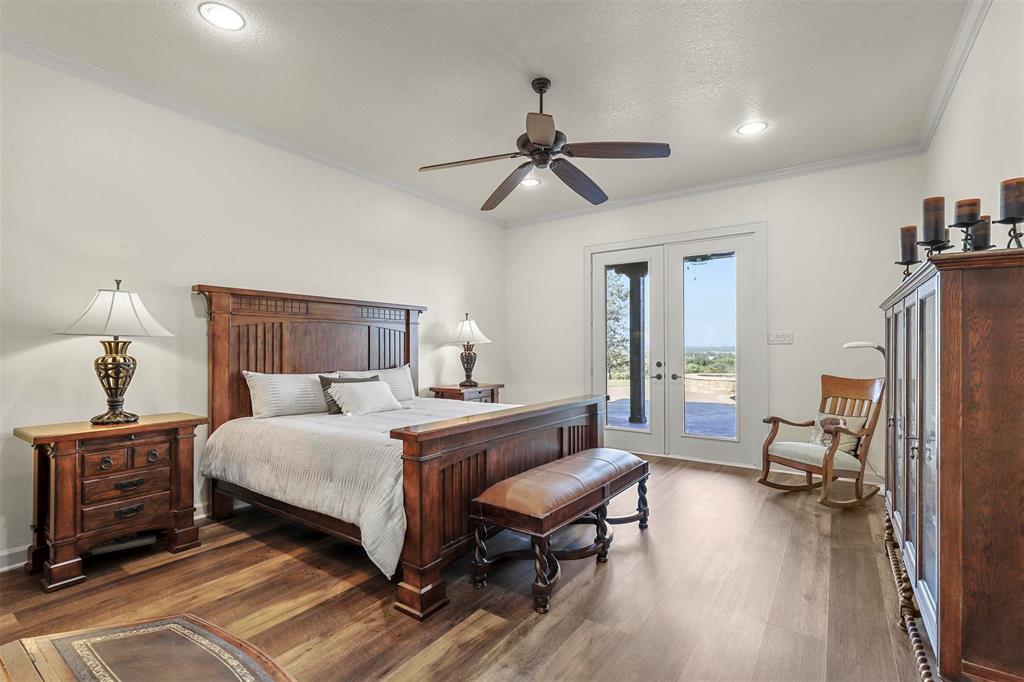 701 Cactus Rio Weatherford, TX 76087 - Photo 20 of 40 a bedroom with a bed furniture and a flat tv screen