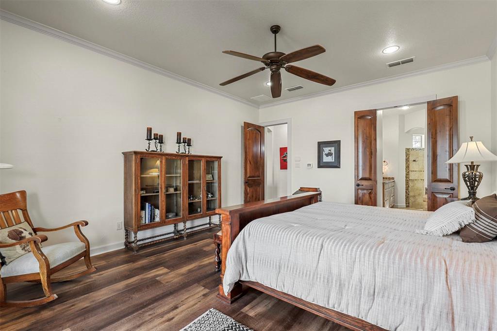 701 Cactus Rio Weatherford, TX 76087 - Photo 21 of 40 a bedroom with a bed and a chandelier