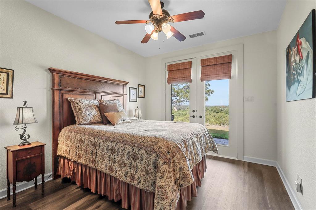 701 Cactus Rio Weatherford, TX 76087 - Photo 24 of 40 a bedroom with a bed and a chandelier