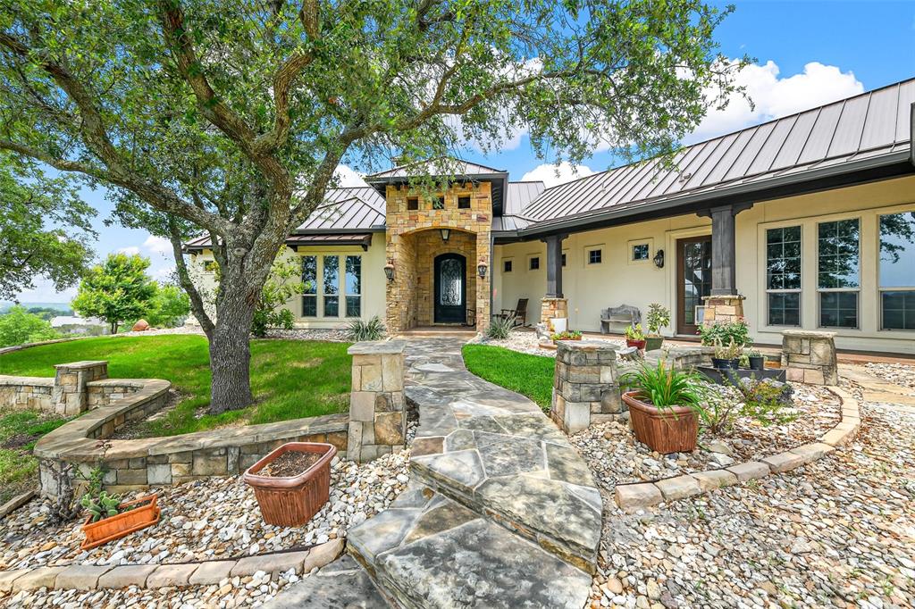 701 Cactus Rio Weatherford, TX 76087 - Photo 4 of 40 a view of a house with backyard sitting area and garden