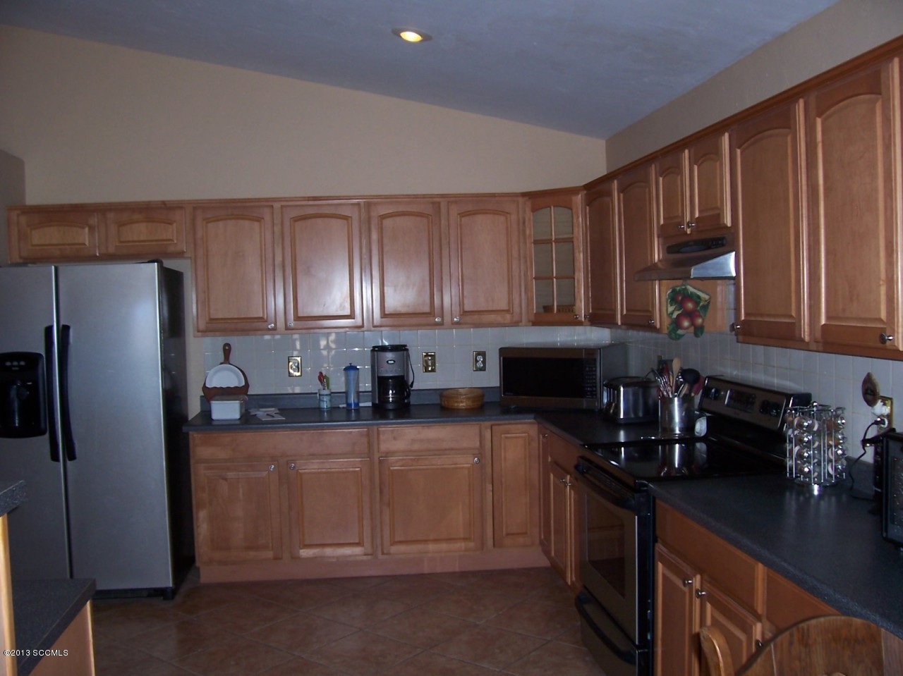 791 Camino Loma Rio Rico, AZ 85648 - Photo 3 of 13 a kitchen with stainless steel appliances granite countertop a stove a sink dishwasher a refrigerator and cabinets with wooden floor