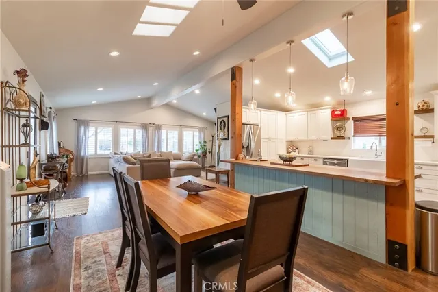 a dining room with furniture and wooden floor