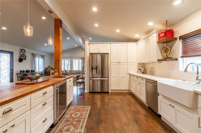a kitchen with granite countertop a sink and stainless steel appliances