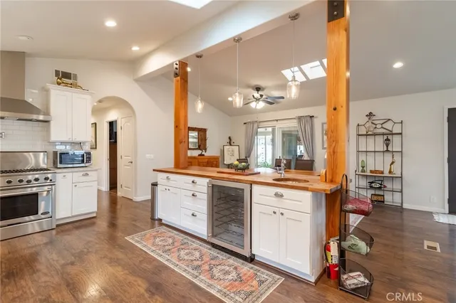 a kitchen with a sink cabinets and wooden floor