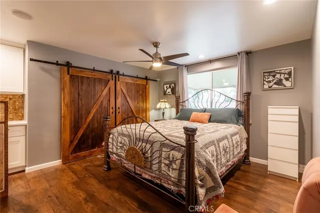 a bedroom with a bed and a ceiling fan