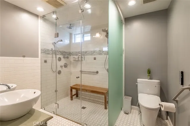 a bathroom with a toilet sink and shower