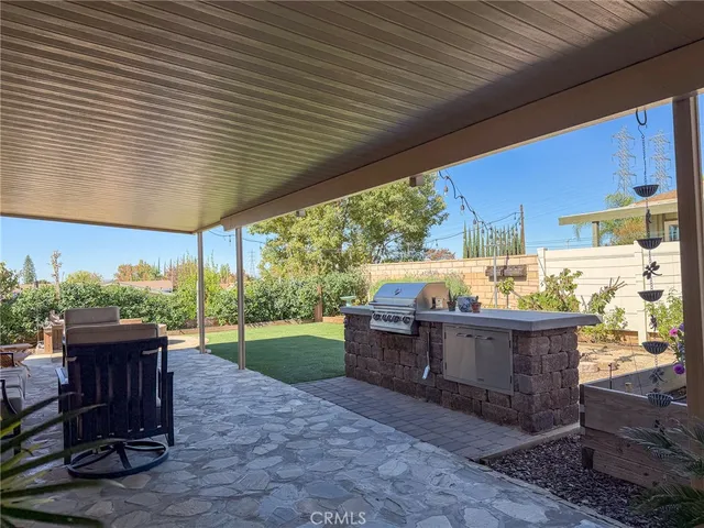 a room with patio furniture and a garden