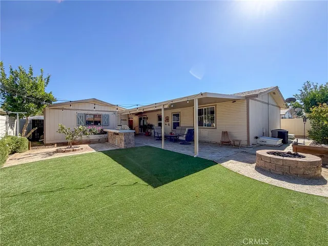 a view of a house with backyard and sitting area